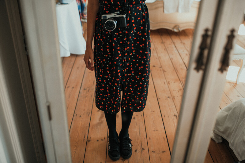 Mirrorless camera hanging on a female photographer.