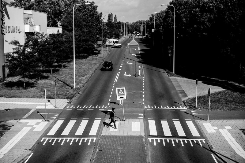 A person crossing a road in Amsterdam.