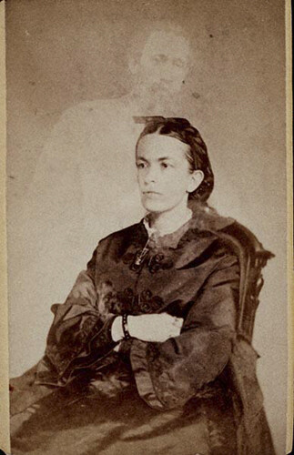 A William Mumler portrait with a ghostly man standing behind the female subject.