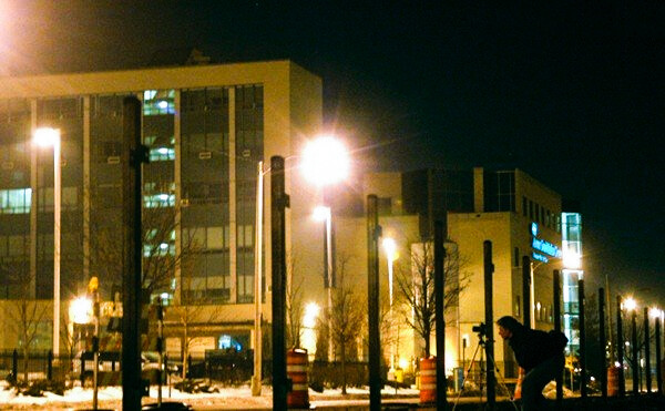 a photographer in a city taking pictures at night