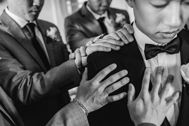 A groom surrounded by groomsmen.