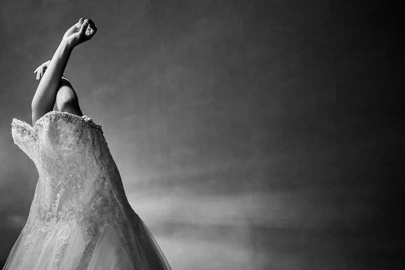 A bride putting on her dress.