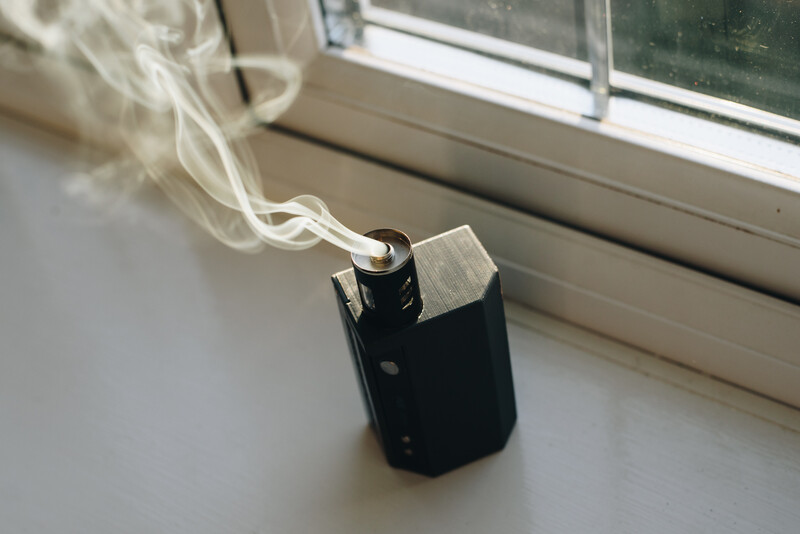 Smoke machine releasing smoke on a windowsill.