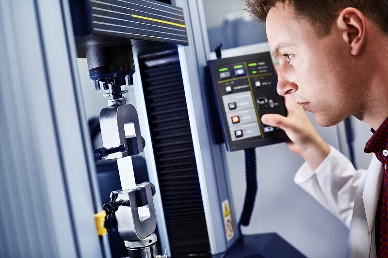 Photograph of a man using an engineering machine.
