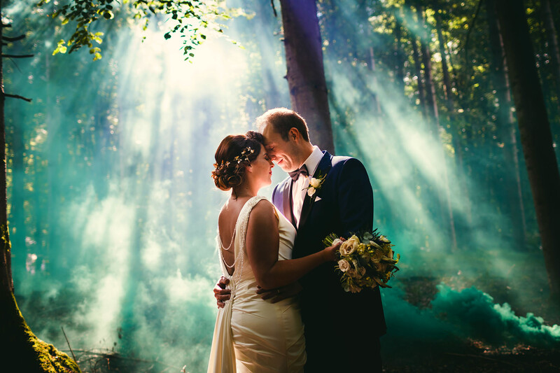 Photograph of a bride and groom in a forest. 