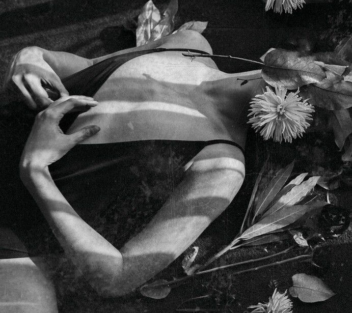A girl's body covered with plants and flowers.