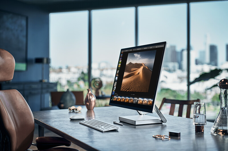 A screen on a desk with photo editing software open.