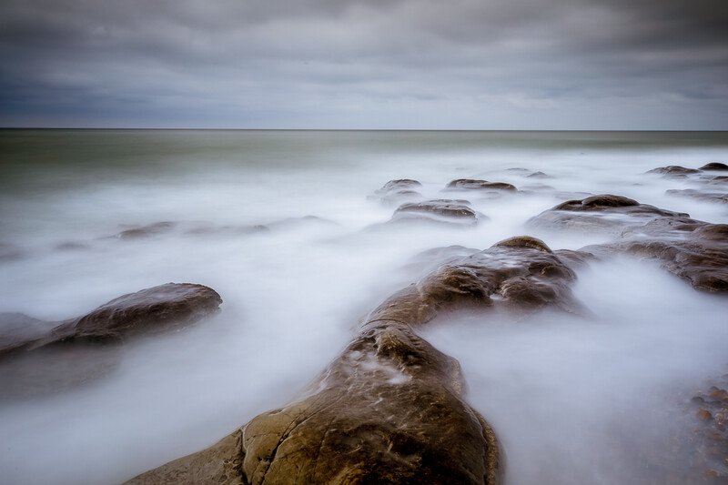 A really long exposure time will transform the moving water into a milk white mist between the rocks. It is something you like or hate.