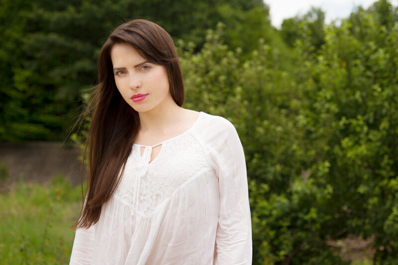 Natural light portrait. Improper editing by removing all shadows on the face.