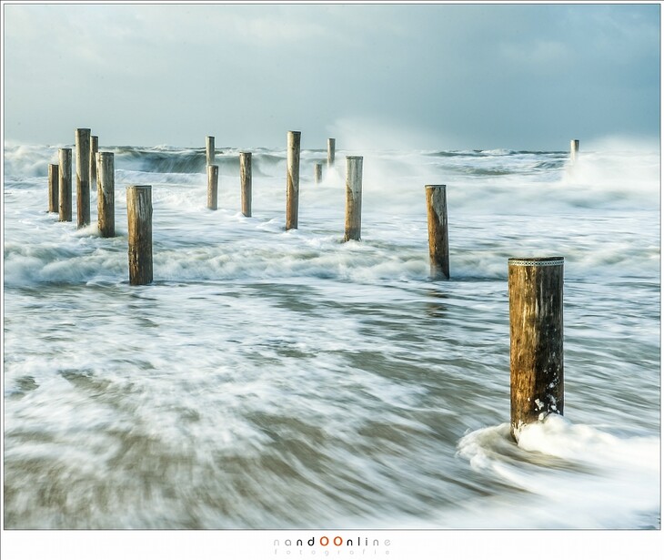The North Sea during a South-West storm. I wanted to catch the strength of the waves hitting the poles and beach. For that I used a 3 stop ND to extend the exposure time enough to capture details in the water (EOS 1Dx + EF24-70L @ 57mm | ISO50 | f/11 | 1/