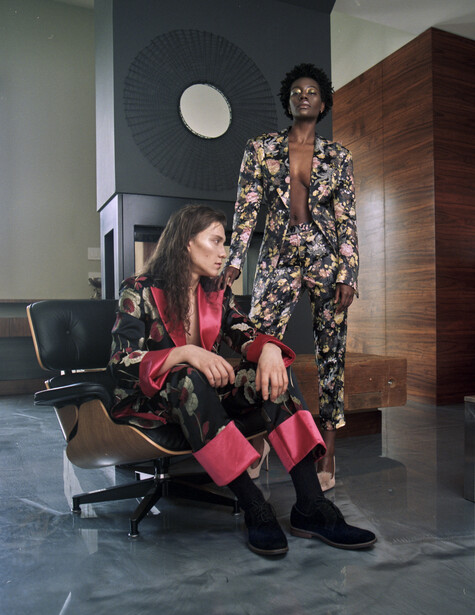 Two models in beautiful home wearing suits without shirts
