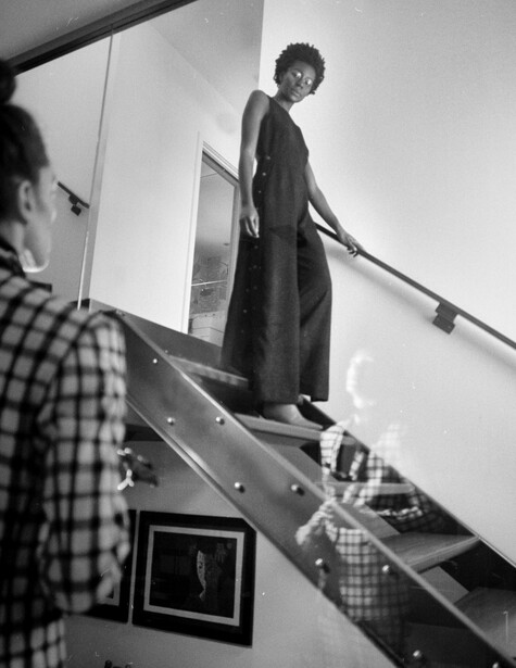 Monochrome photo woman walking down stairs
