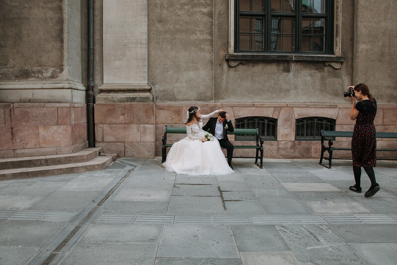 A wedding photographer photographing bride and groom