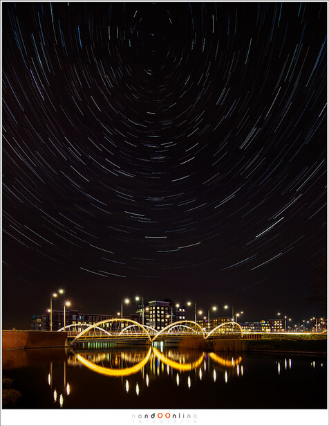 It is easy to shoot star trails in the middle of the city, if the settings are correct. This is composed from 329 individual shots, each 8 seconds at ISO3200 and f/8, and a seperate foreground shot. (EOS 5D mark III + TS-E 17mm | ISO3200 | f/4 | 329x 8 se