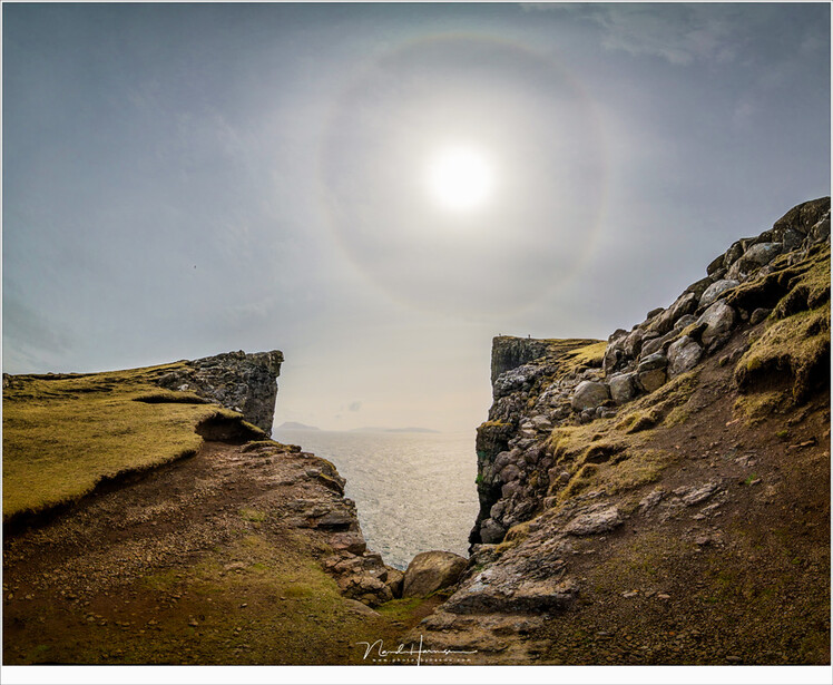A halo around the sun over Trælanípa at the Faroe Islands. Halos are more common than rainbows, they say. (Canon EOS 5D4 with Laowa 12mm | ISO400 | f/8 | 1/2000 | four vertical images stiched)