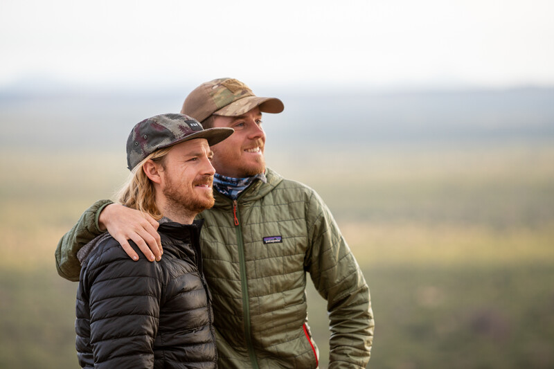 Two men posing for a photograph in an outdoor setting.