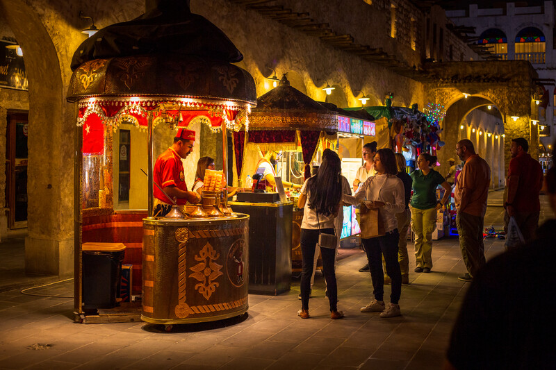 a Turkish ice-cream vendor at work in Doha, Qatar, at night.