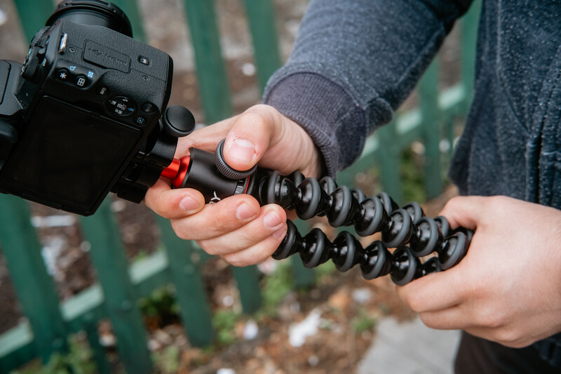 Black Joby tripod with a camera mounted