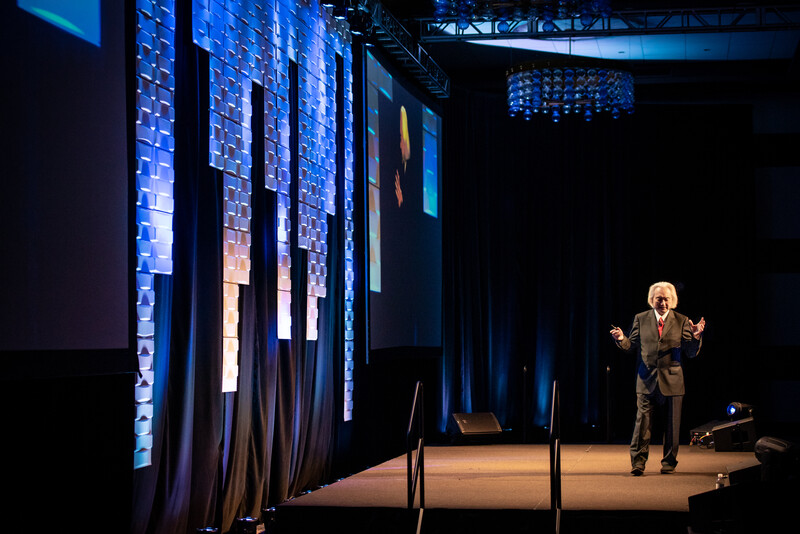 Michio Kaku delivers a speech on stage
