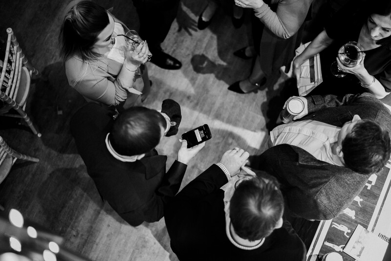 Wedding guests in a circle having a drink