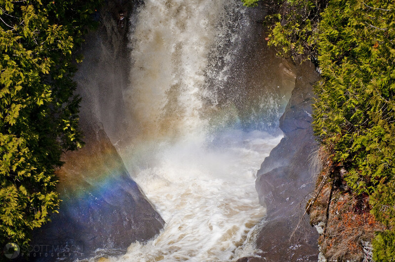 A rainbow in front of a waterfall