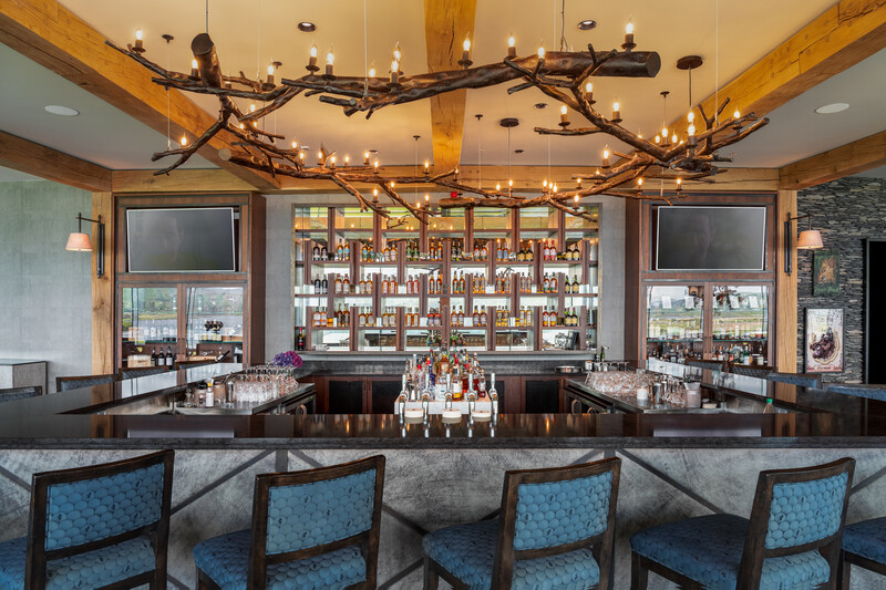 hotel bar with high stool seating and oak-wood timber beams above