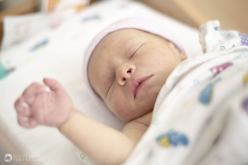 a newborn baby sleeping in a hospital