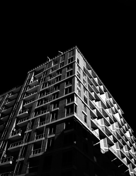 black and white building with a dark sky