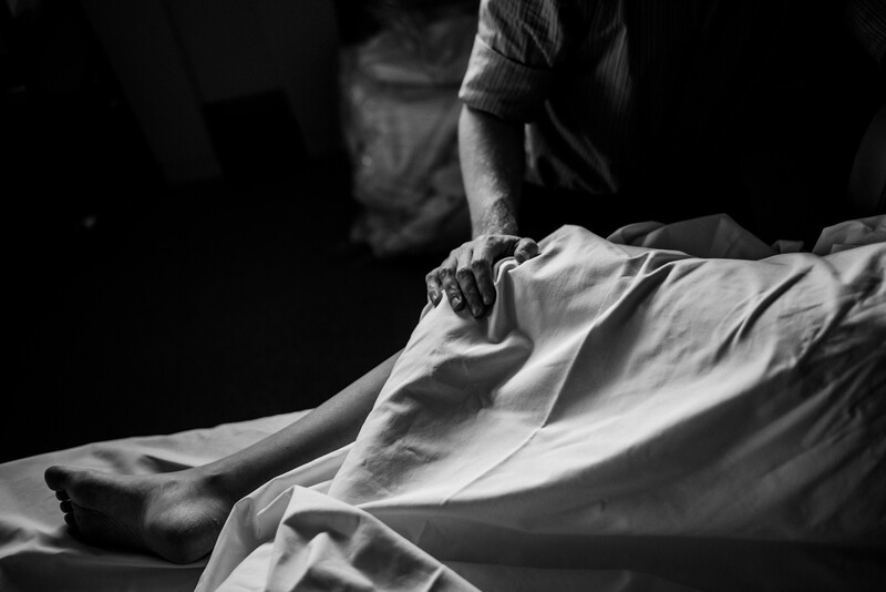 A father comforting a mother about to give birth in hospital