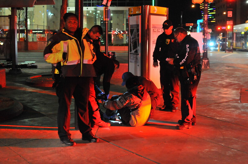 Paramedics attending a scene of an injured person.