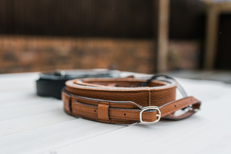 Black and brown leather camera strap