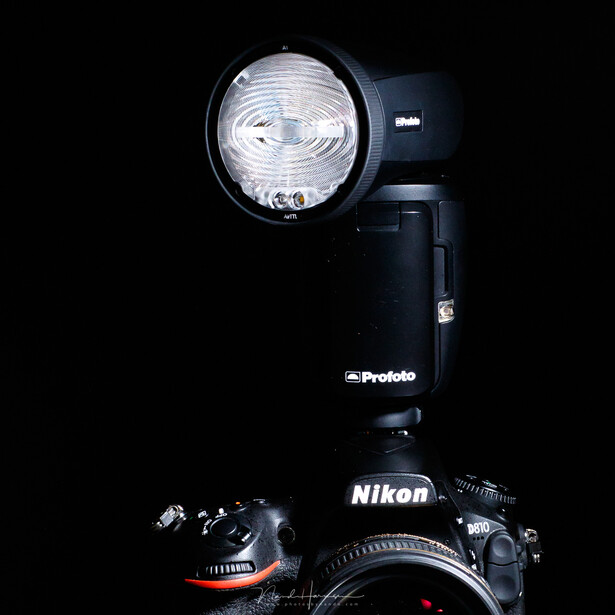 A modern on-camera flash with a swivel head that enables you to direct the light.