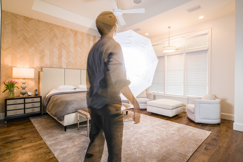 a man holding an umbrella flash inside a bedroom