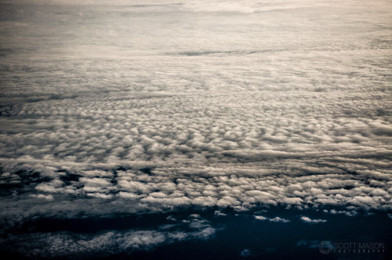 view from an airplane window of clouds below