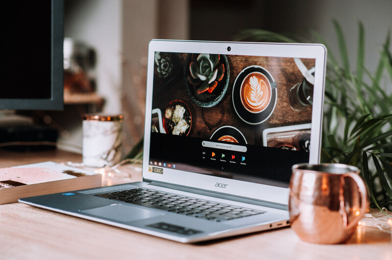 Acer laptop with a cup of tea on a desk