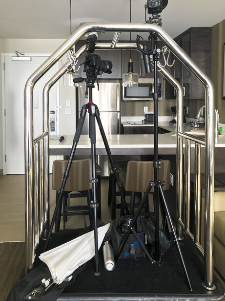 photography gear on a bellhop cart in a hotel