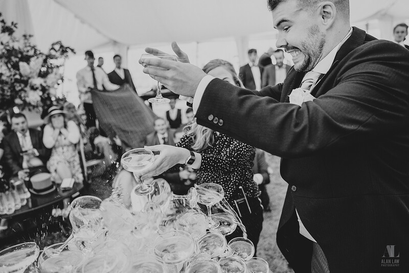 A goom dropping wedding toast glasses.