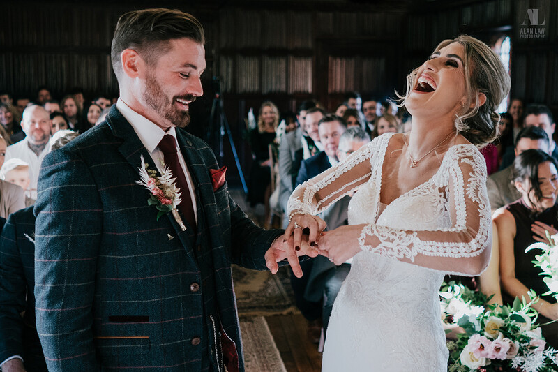 A bride putting a wedding ring onto groom's finger