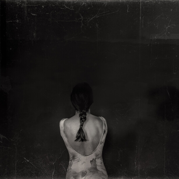 A back view of a dark haired girl.
