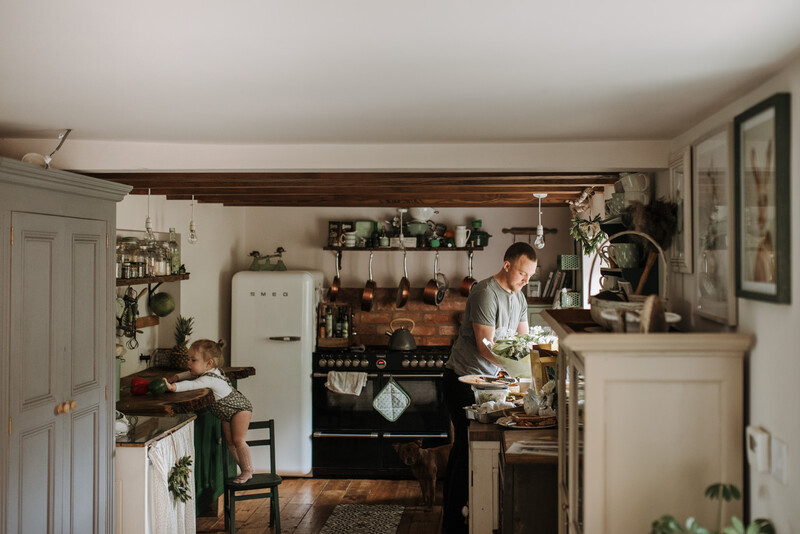 A father and daughter cooking in the kitchen.