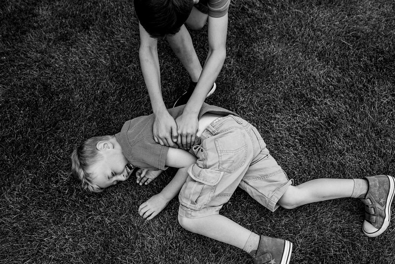 Two young boys playing outdoors.