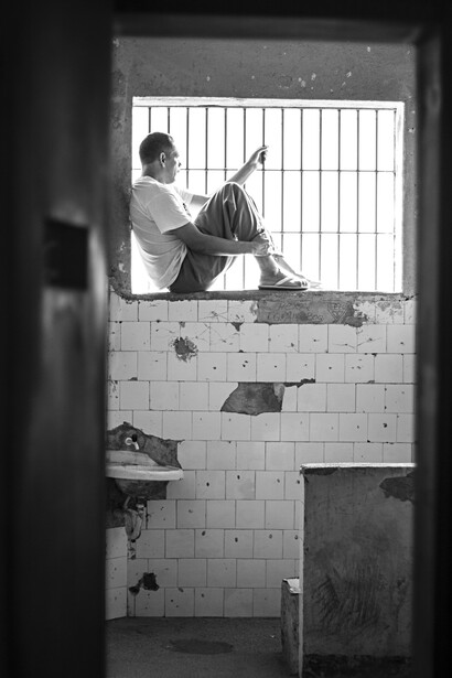 A male inmate inside his prison cell.
