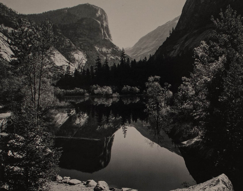 an Ansel Adams image of a mountain scene mirrored in a lake
