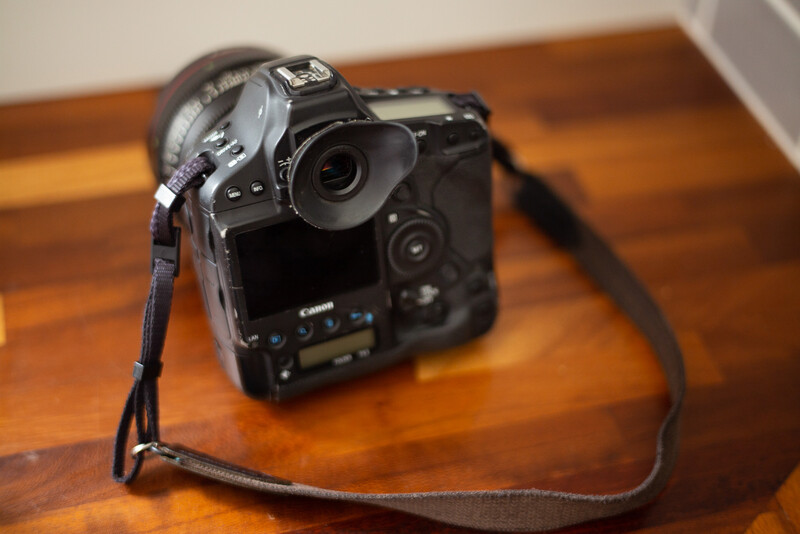 Camera strap and viewfinder hood