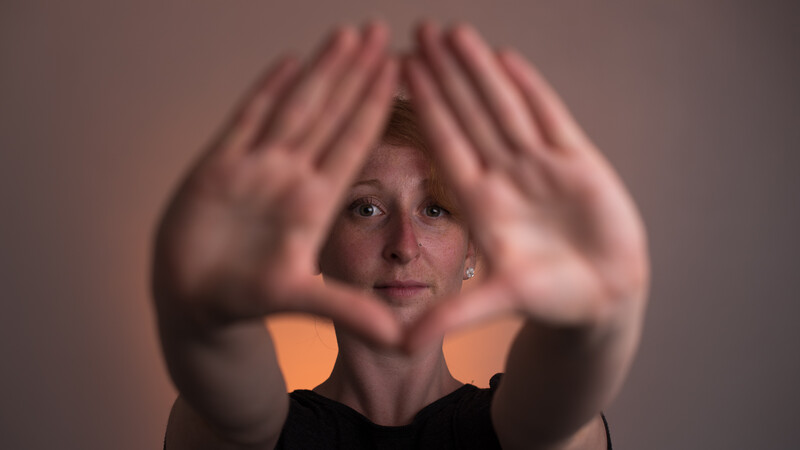 Hands framing face