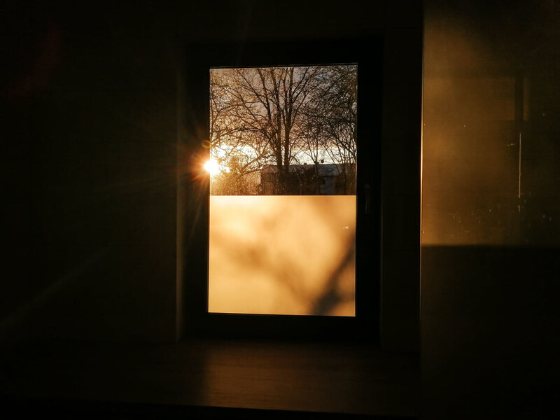A sun rise coming through the window
