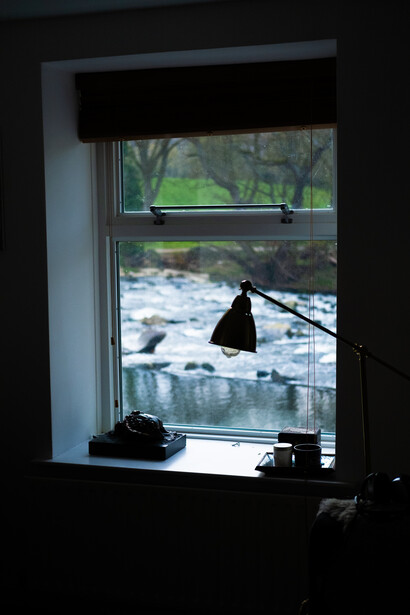 A window with a river in the background