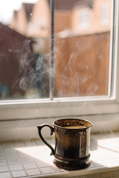 A coffee mug on a windowsill.