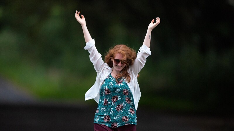 Portrait of woman with arms in the air
