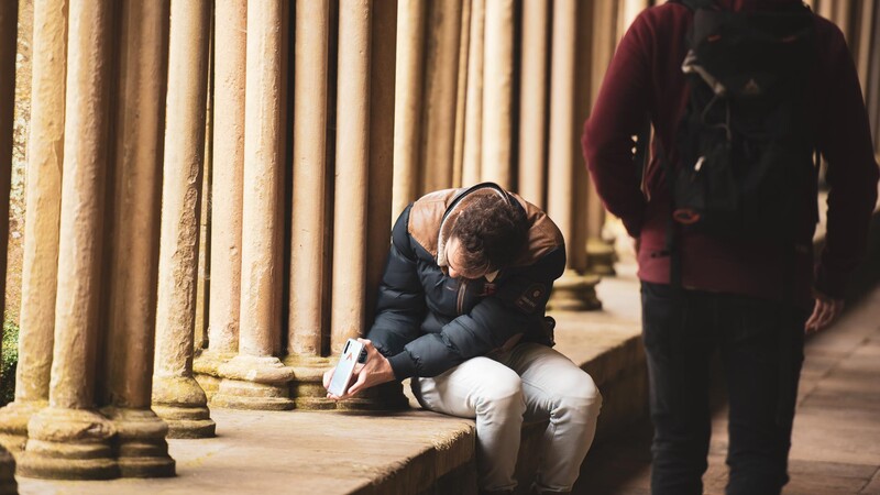 Man with smartphone in tourist spot taking photo